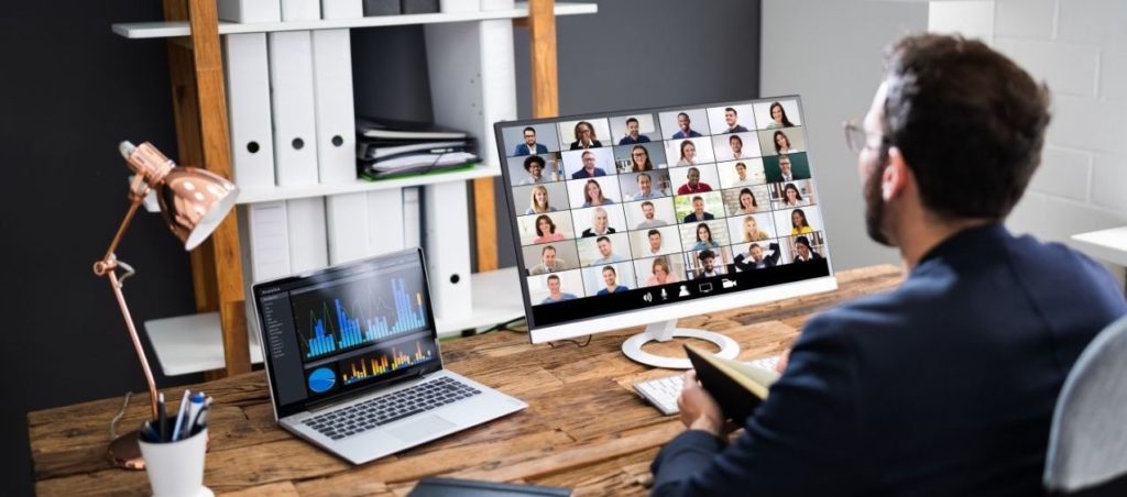 BANNER OF MAN LOOKING AT CLIENT ON COMPUTER SCREEN