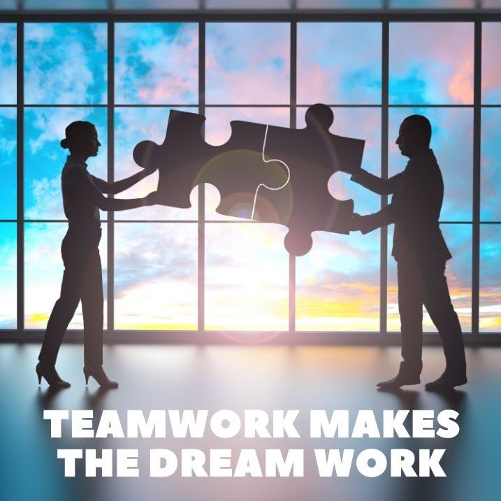 PARTNERSHIP TWO PEOPLE HOLDING PUZZLE PIECES TEAMWORK MAKES THE DREAM WORK